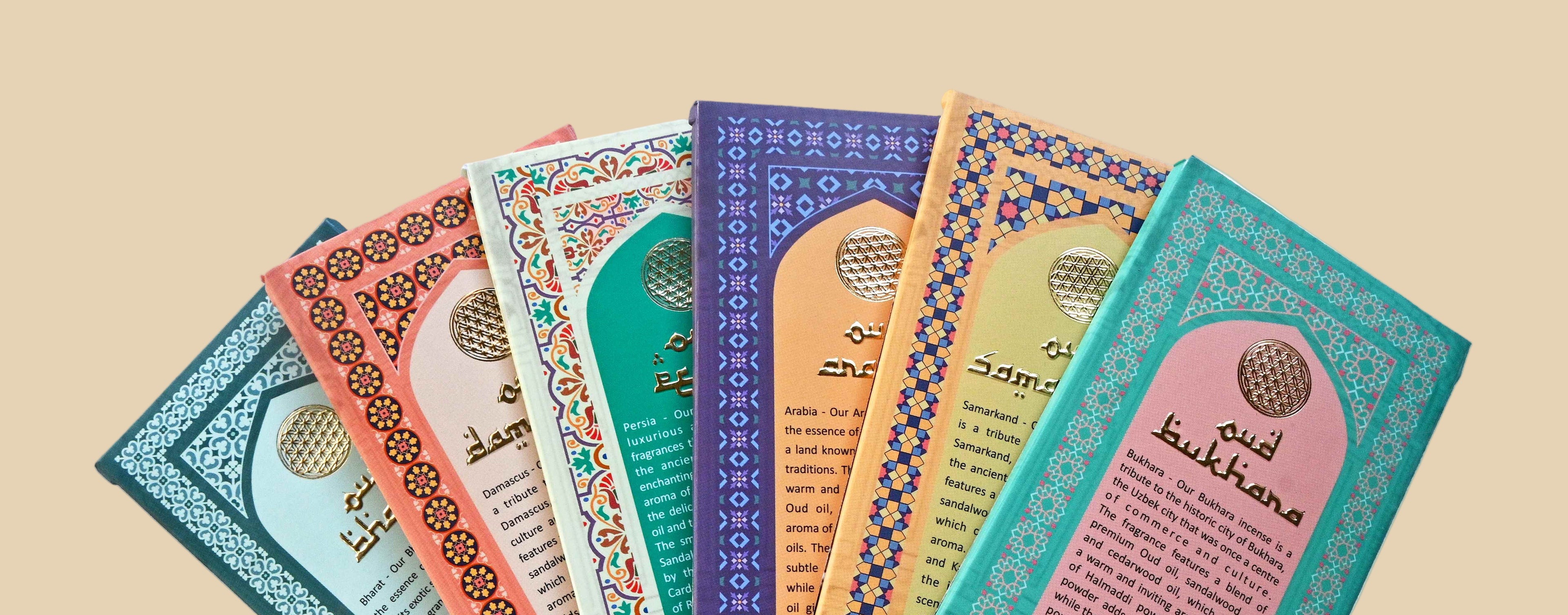 Set of colorful incense boxes with intricate designs on a white background
